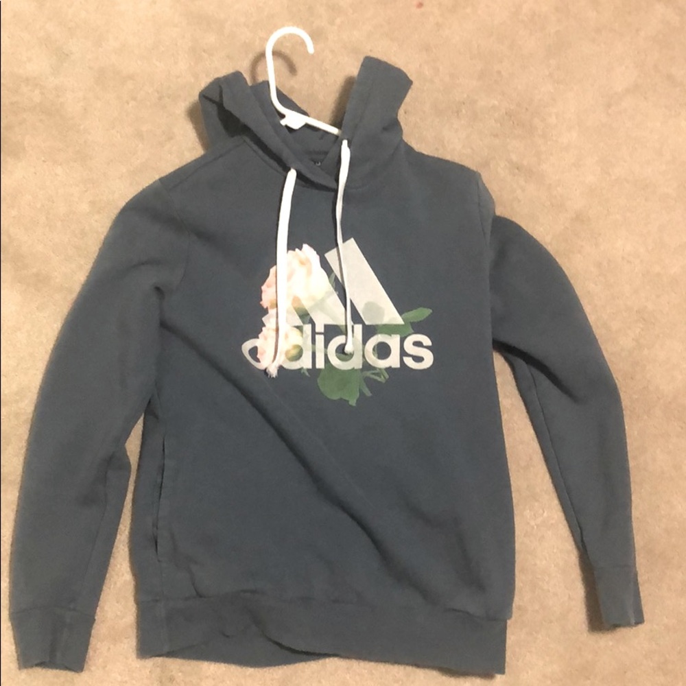 Adidas blue hoodie with logo and flowers.